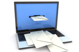 envelopes being delivered through a laptop screen